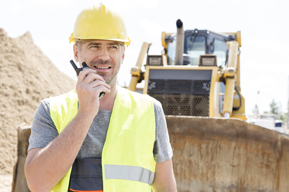 Supervisor using a BK radio at a construction site
